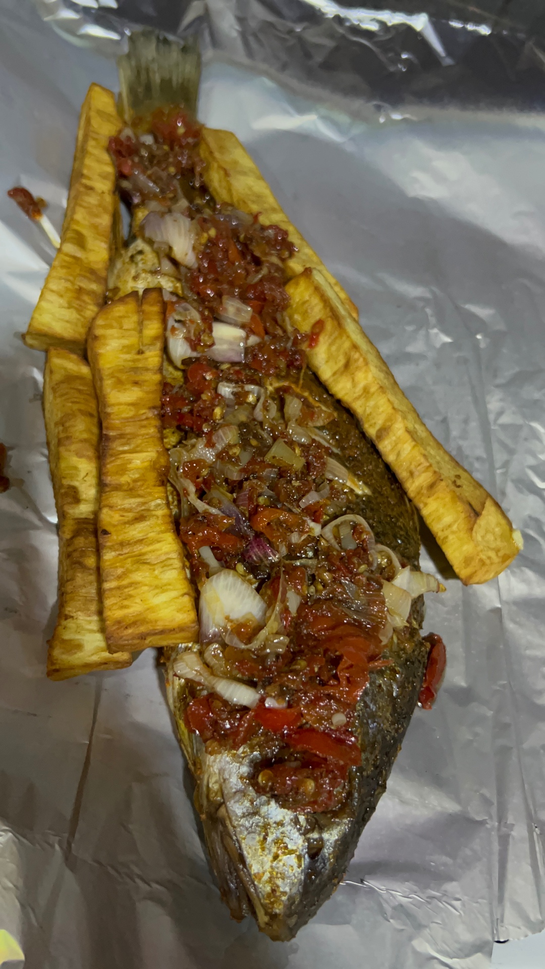 Grilled croaker with fried plantain strips and pepper sauce