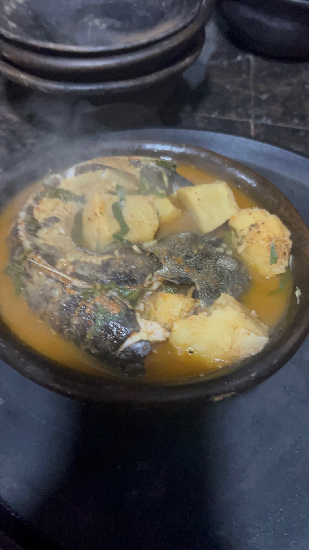 Catfish pepper soup with yam served in a traditional earthenware pot