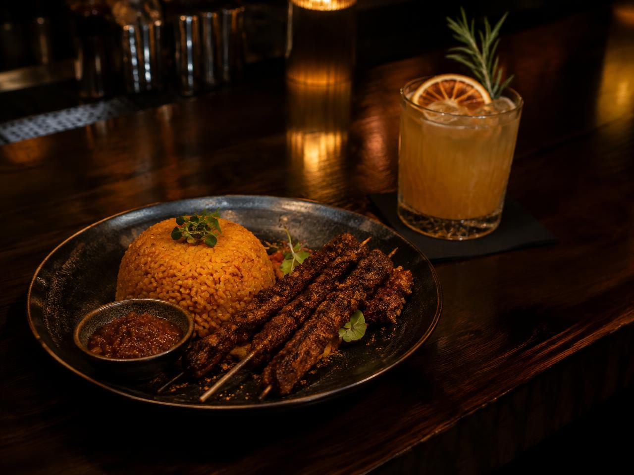 Suya and jollof with a cocktail